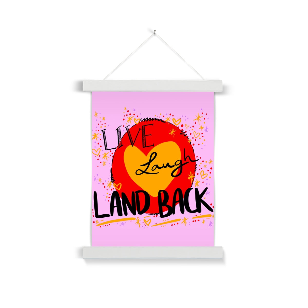 White wooden poster hanger. The art print is rectangle. The design: ‘live laugh land back’ written in black with a yellow heart and red circle behind. The background is pink with small dots, squiggles, stars and hearts dotted around the image in red, yellow and purple.