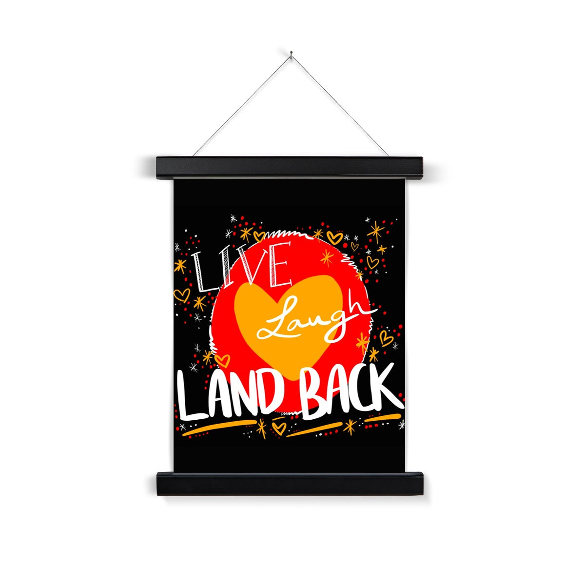 A black wooden poster hanger. The print is rectangle. The design: ‘live laugh land back’ written in white with a yellow heart and red circle behind. The background is black with small dots, squiggles, stars and hearts dotted around the image in red, yellow and white.