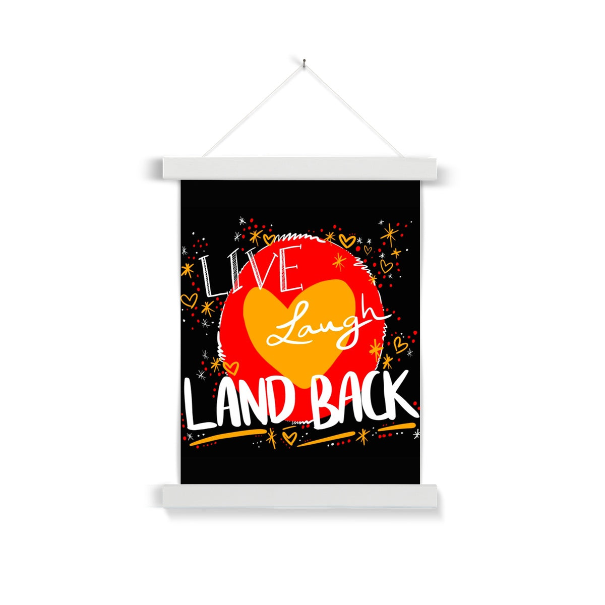 A white wooden poster hanger. The print is square. The design: ‘live laugh land back’ written in white with a yellow heart and red circle behind. The background is black with small dots, squiggles, stars and hearts dotted around the image in red, yellow and white.