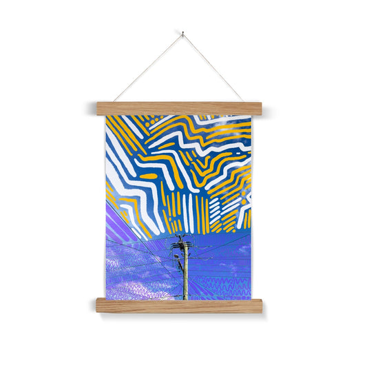 A light wooden poster hanger. The art print: a digital collage of a powerline surrounded by blue sky. There are purple lines/circles/squiggles doodles around the powerline and about is thick white and yellow doodle lines.