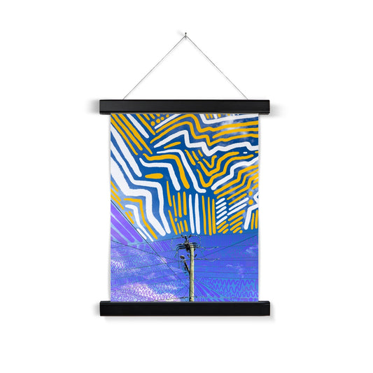 A black wooden poster hanger. The art print: a digital collage of a powerline surrounded by blue sky. There are purple lines/circles/squiggles doodles around the powerline and about is thick white and yellow doodle lines.