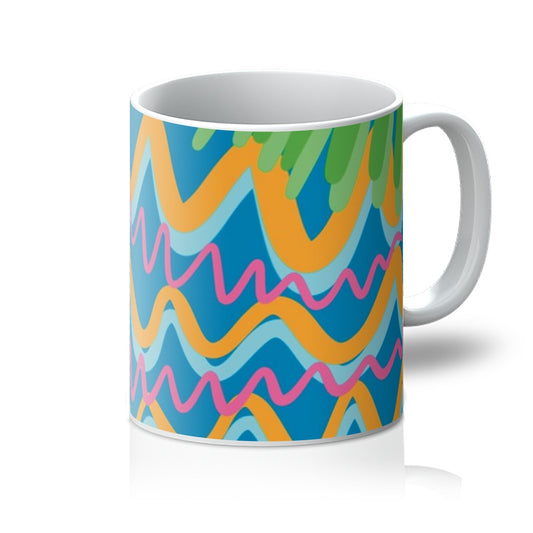 White mug with art print. Art background is mid blue, there are light blue snd marigold squiggles that shadow each other, mid and light green stripes that shadow each other, and hot pink squiggles that are thinner then the other shapes. Handle is on the right. 